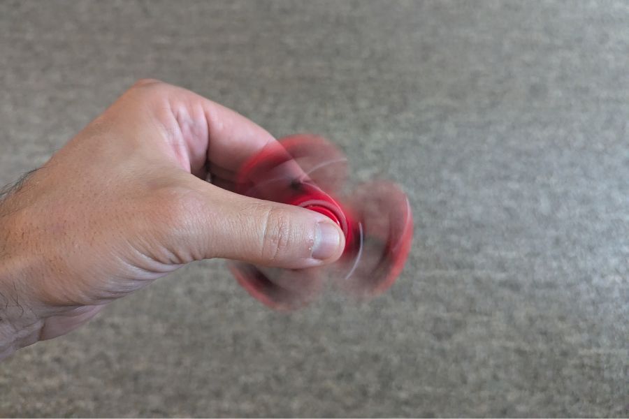 a hand using a fidget spinner toy